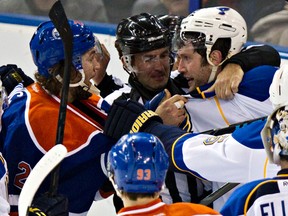 Oilers big man Luke Gazdic stares down Blues captain David Backes the last time the two teams met at Rexall Place on Dec. 21. (Codie McLachlan, Edmonton Sun)