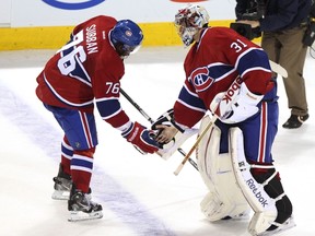 Carey Price is congratulated by teammate P.K. Subban October 29, 2011. (REUTERS/Christinne Muschi)
