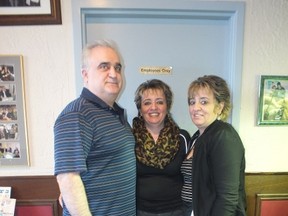 Jim Mandrapilias stands beside his wife Dimi, right, and her identical twin Bessie Aspropotamitis. The three are co-owners of the Lord Gainsborough restaurant, celebrating 28 years open on January 15.