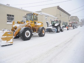 A convoy of blowers sits outside Bartliff's Bakery Wednesday, Jan. 8.