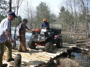 Hunters build a bridge across a swamp so they can hunt more land.
