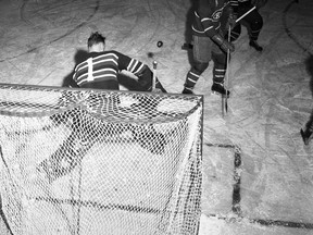 Montreal Canadiens forward “Boom Boom” Geoffrion watches the puck as Strathroy Rockets goaltender Harvey Jessiman makes a save. 
Photo courtesy of The London Free Press Collection of Photographic Negatives, Western Archives, Western University.