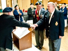 Dick Waywood (right) is once again sworn in as president of the Pincher Creek Legion. 2014 marks his third consecutive term in office. Bryan Passifiume photo/QMI Agency