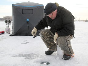 Joe Thompson, 50, waits for a bite on Sarnia Bay. The Sarnia man was angling for perch and rainbow trout at the popular ice fishing spot. Thompson said he's been ice fishing since he was a boy. TYLER KULA/ THE OBSERVER/ QMI AGENCY