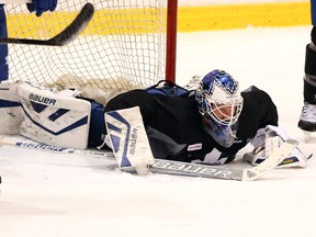 Goalie James Reimer stretches during the Toronto Maple Leafs practice in Toronto on Wednesday, January 8, 2014. (Veronica Henri/Toronto Sun)