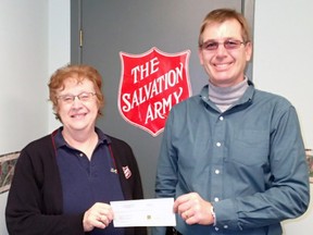 St. Paul’s United Church supported the outreach efforts of the Tillsonburg Salvation Army over the Christmas season by donating $580 in gift cards, several mittens, scarves and hats as well as over $900 in cash. Donna Acre, Salvation Army Community Ministries Coordinator (left) accepted the cheque from St. Paul’s United Council Chair, Glenn Buchner. Contributed Photo