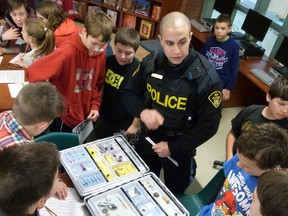 Oxford OPP Constable Charlie Abdul-Massih warns Monsignor O’Neil students about the characteristics, effects, and dangers of drugs as part of the school’s VIP program. Photo Courtesy of Jennifer Van Acker-Barlow