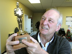 Kingston Symphony conductor Glen Fast, who will be leading the orchestra in a night of music from the movies Jan. 18 at the Grand Theatre, holds a replica Oscar in the symphony office.
Michael Lea The Whig-Standard