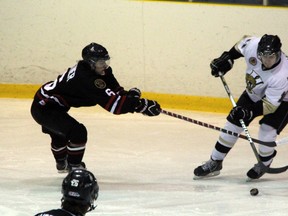 Josh Kestner of the Sarnia Legionnaires (in black) and Mark Manchurek of the LaSalle Vipers battle for a puck in the second period of their game at the Brock Street Barn on Thursday, Jan. 9. Kestner was the first star of the game with two goals and an assist in a 5-4 Legionnaires victory. SHAUN BISSON/ THE OBSERVER/ QMI AGENCY