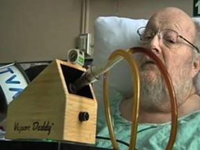 Terminal cancer patient Charles Bury smokes marijuana in his room at CHUS hospital in Quebec. (TVA/QMI Agency)