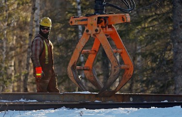 A CN worker looks on while working on the railway in Plaster Rock, New Brunswick, January 8, 2014. A Canadian National Railway train carrying crude oil and propane derailed and caught fire in New Brunswick on Tuesday night after the emergency brakes were activated, federal safety officials said on Wednesday. REUTERS/Mathieu Belanger (CANADA - Tags: DISASTER ENERGY TRANSPORT)