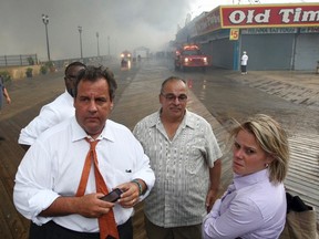 New Jersey Governor Chris Christie (2nd L) tours the fire area with his Deputy Chief of Staff Bridget Anne Kelly (R) and Office of Emergency Management personnel at the boardwalk in Seaside Heights, New Jersey on September 12, 2013 in this handout photo obtained by Reuters on January 9, 2014. REUTERS/Tim Larsen/Governor's Office/Handout via Reuters