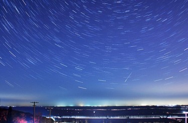 A meteor streaks past stars during the annual Quadrantid meteor shower in Qingdao, Shandong province, January 4, 2014. Picture taken with a long exposure. Picture taken January 4, 2014. REUTERS/Stringer
