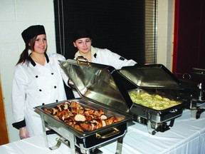 Tonica Kirchner (left) and Jessica Gagne show off the main courses for Wednesday night’s Gourmet Cabaret at St. Thomas Aquinas High School. The two Grade 12 students were part of the Hospitality and Tourism class which prepared the meal as a final exam
