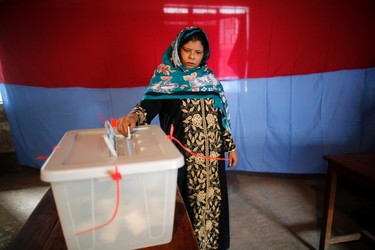 A woman casts her vote at a polling centre during parliamentary elections in Dhaka January 5, 2014. Bangladesh voted amid heavy security on Sunday in parliamentary elections boycotted by the main opposition, marred by violence that has killed more than 100 people and shunned by international observers as flawed. REUTERS/Andrew Biraj