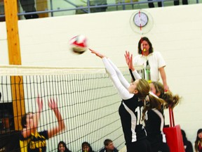 St. Thomas Aquinas Saints Emme Thompson (inside right) and teammate Cassidy Swejda set the block against Rainy River on Thursday in NorWOSSA ‘A’ senior girls volleyball play. The Saints won the game in three straight sets.