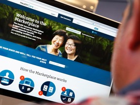 A man looks over the Affordable Care Act (commonly known as Obamacare) signup page on the HealthCare.gov website in New York in this October 2, 2013 photo illustration. REUTERS/Mike Segar/Files