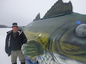 Al Macintyre, president of the Petrie Island Ice Fisherman's Association, poses with Wally on Baitshop Bay. The 22-foot walleye, which can't be missed by Hwy. 174 commuters, is a working ice hut aimed at promoting what boosters say is a growing family pastime. (MEGAN GILLIS/Ottawa Sun/QMI Agency)