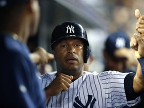 Vernon Wells of the New York Yankees is congratulated after stealing home plate on the back end of a double steal against the Chicago White Sox during the second inning in a MLB baseball game at Yankee Stadium on September 3, 2013 in the Bronx borough of New York City. (Rich Schultz/Getty Images/AFP)