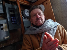 Stephen Taylor, 61, in his Scarborough home on Jan. 9, 2014. He's been without electricity for 10 months in a dispute with Toronto Hydro. (Dave Thomas/Toronto Sun)