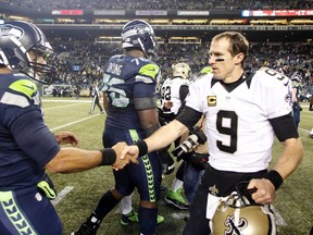 Seattle Seahawks quarterback Russell Wilson (3) and New Orleans Saints quarterback Drew Brees (9) shake hands following a 34-7 Seattle victory at CenturyLink Field earlier this season. (Joe Nicholson-USA TODAY Sports