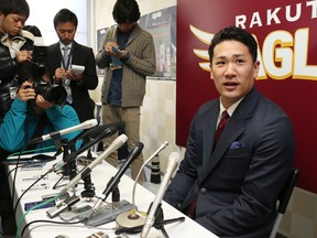Japanese star pitcher Masahiro Tanaka of Rakuten Eagles speaks before the press after meeting with his team's president in Sendai in Miyagi prefecture, northern Japan on December 17, 2013. (AFP PHOTO/JIJI PRESS)