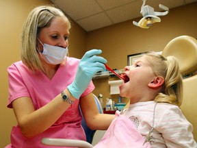 Dental hygienist Stephanie Holoway cleans the teeth of a patient. 
Luke Hendry/The Intelligencer/QMI Agency