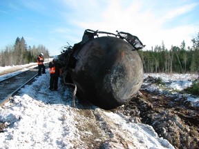 Investigators work at the scene of a January 7 derailment involving Canadian National Railway (CN) mixed freight train near Plaster Rock, New Brunswick in this image obtained from The Transportation Safety Board of Canada on January 10, 2014. (REUTERS/The Transportation Safety Board of Canada/Handout via Reuters)