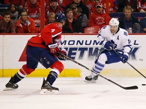 Toronto Maple Leafs centre Jay McClement (11) skates with the puck as Washington Capitals defenceman John Erskine (4) defends in the first period at Verizon Center. (Geoff Burke-USA TODAY Sports)