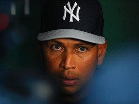 New York Yankees third baseman Alex Rodriguez talks to reporters in the dugout before their game against the Boston Red Sox at Fenway Park in Boston August 16, 2013. (REUTERS/Brian Snyder)