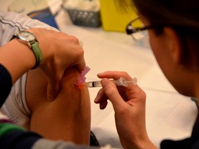 An Ottawa Public Health nurse gives someone a flu shot during a vaccine clinic at the city building on Constellation Dr. The agency held two flu shot clinics on the weekend to meet increased demand for the vaccine
Chris Hofley/Ottawa Sun/QMI AGENCY