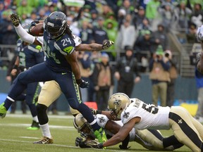 Seattle Seahawks running back Marshawn Lynch (24) runs past the New Orleans Saints for a touchdown during the first half of the 2013 NFC divisional playoff football game at CenturyLink Field. (Kirby Lee-USA TODAY Sports)