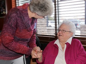 Helen McAvoy, right, receives the Women of Excellence award during the Belleville Agricultural Society Awards Sunday afternoon at Boston Pizza in Belleville, ON. Presenting the award is Geraldine Logan, secretary of the Hastings District Womens Institute. 
EMILY MOUNTNEY/THE INTELLIGENCER/QMI AGENCY