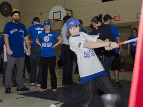 Zachary Sampson from the Boys and Girls Club of Kingston takes a swing with Toronto Blue Jays first baseman Adam Lind watching during the Blue Jays Winter Tour visit on Saturday. Julia McKay The Whig-Standard