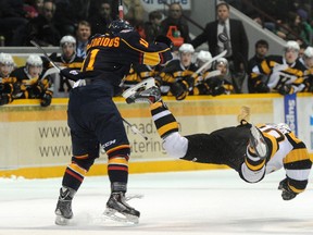 Nick Pastorious of the Barrie Colts delivers a mid-ice hit to Mark Lemmon of the Kingston Frontenacs during OHL action Saturday at the Barrie Molson Centre. Mark Wanzel The Barrie Examiner