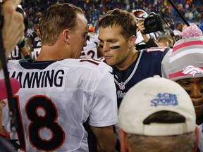 New England Patriots quarterback Tom Brady (R) speaks with Denver Broncos quarterback Peyton Manning at the conclusion of the second half of their NFL football game in Foxborough, Massachusetts October 7, 2012. (REUTERS/Jessica Rinaldi)