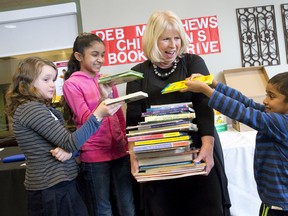 London North Centre MPP Deb Matthews gets help collecting books from Sydney Powell, left, Shila Biswa and Xavier Rahman as she kicks off her 10th Children's Book Drive at the Ivey Spencer Leadership Centre on Windermere Rd. in London Sunday. Inspired by former lieutenant-governor James Bartleman's push to donate books to northern Ontario First Nations communities, Matthews started a drive to give books within the London community. Books can be dropped off at Matthews' riding office at 242 Piccadilly St. until Jan. 31. (CRAIG GLOVER, The London Free Press)