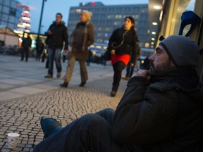 A homeless man begs for money at Alexanderplatz square in Berlin, December 20, 2012.  REUTERS/Thomas Peter