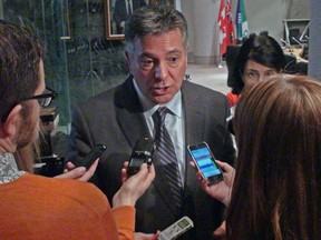 Files: Ontario Finance Minister Charles Sousa talks with reporters at Ottawa City Hall after a breakfast speech to the business community on Monday, Jan. 13, 2014. (JON WILLING/OTTAWA SUN)