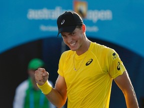 Vasek Pospisil celebrates defeating Samuel Groth at the Australian Open in Melbourne on Monday, Jan. 13, 2014.  (Bobby Yip/Reuters)