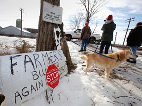 About a dozen protesters and supporters of long-time Quinte West farmer Frank Meyers show their support along the CN railway, near Meyers' farm land, which is now owned by the Department of Natinal Defence, Monday morning, Jan. 13, 2014. -  File photo by: JEROME LESSARD /The Intelligencer/QMI Agency