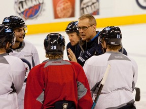 Winnipeg Jets new head coach Paul Maurice chats with a few of his players during a pre-game skate held Jan. 13 at the MTS Centre. (BROOK JONES/QMI AGENCY)