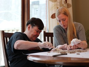 L?Arche core member Janet Blair makes a mosaic cross with the help of her live-in assistant Rachel Amaral.