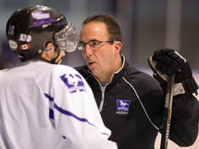 Western Mustangs men?s hockey coach Clarke Singer talks intently with Adam McKee at practice at Thompson arena on Monday. (Mike Hensen/The London Free Press)