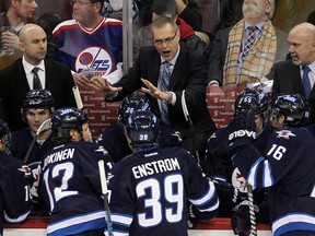 Winnipeg Jets head coach Paul Maurice (c) and assistant coaches Pascal Vincent (l) and Charlie Huddy direct players during NHL hockey against the Phoenix Coyotes in Winnipeg, Man. Monday, January 13, 2014.
Brian Donogh/Winnipeg Sun/QMI Agency