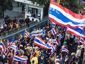 Anti-government protesters stand at the gate of the Custom Department office in Bangkok during a protest January 14, 2014. REUTERS/Nir Elias