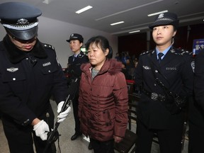 Zhang Shuxia, an obstetrician involved in baby trafficking, stands trial in Weinan Intermediate People's Court in Weinan, Shaanxi province, December 30, 2013. (REUTERS/China Daily)