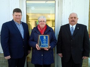 Lambton County Warden Todd Case presents his citizen of the month award to Oil Springs resident Cathy Martin. They are joined by Oil Springs Mayor Ian Veen. (Submitted photo)