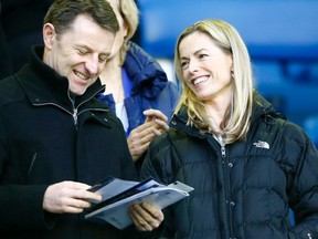 The parents of missing British child Madeleine McCann, Gerry, left, and Kate McCann, smile before watching Everton play Queens Park Rangers' in their English FA Cup soccer match at Goodison Park in Liverpool, northern England on January 4, 2014. (REUTERS/Darren Staples)