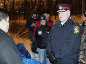 Aamjiwnaang First Nation Chief Chris Plain, left, converses with Sarnia Police Chief Phil Nelson prior to a celebratory ceremony at the CN rail blockade on Williams Dr. in January 2013. (QMI Agency file photo)